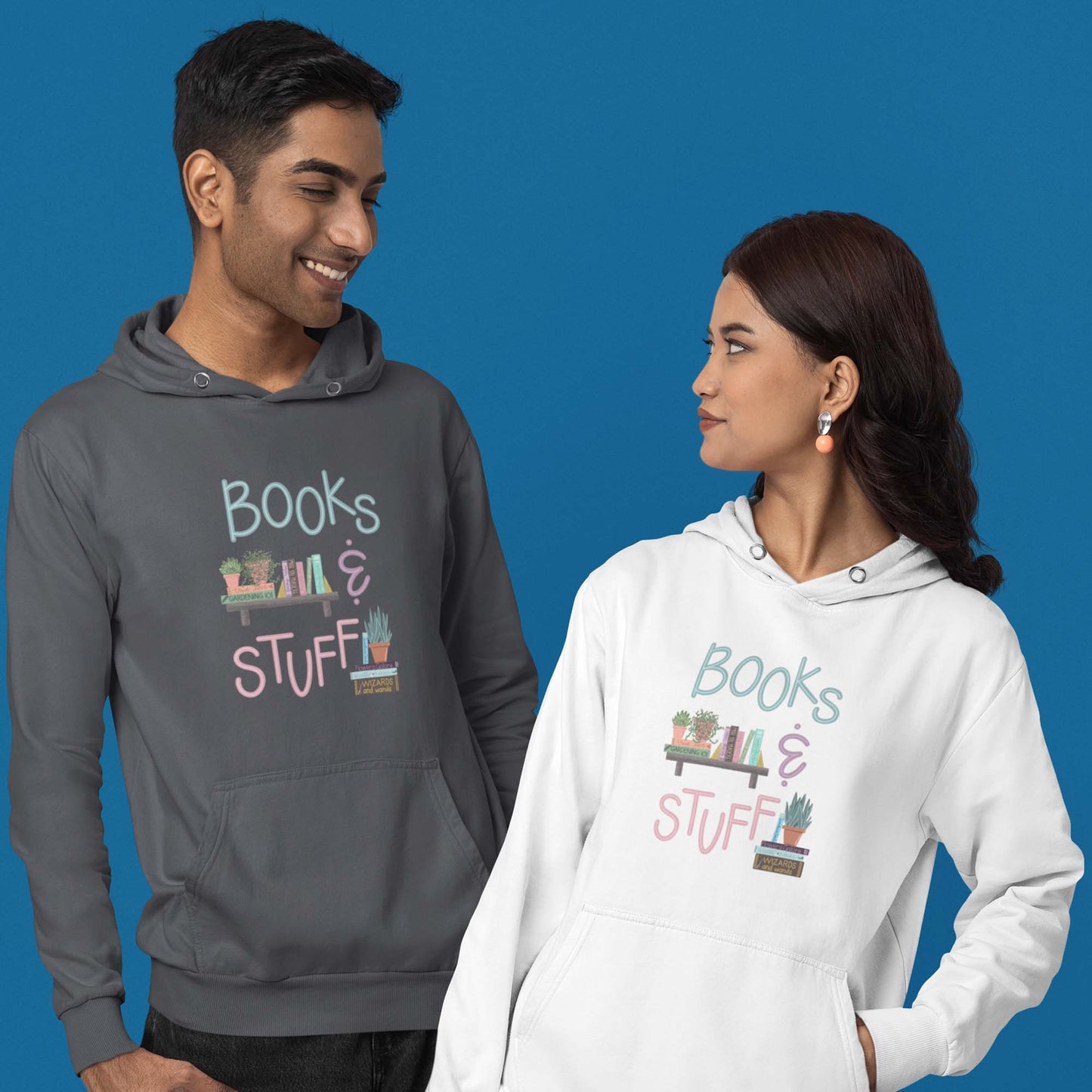 One male and one female models wearing of Moxie•Pop's unisex graphic hoodie with "Books & Stuff" with books and house plants artwork in dark heather and white