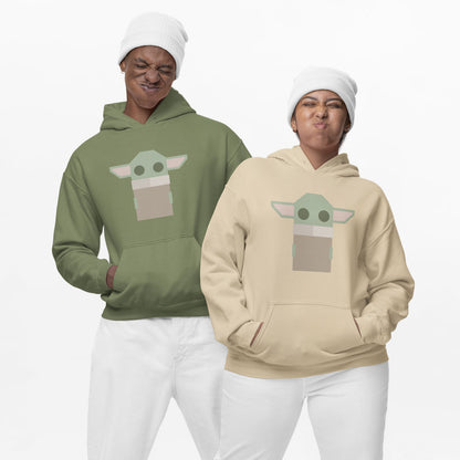 Modeled product image of Moxie•Pop's unisex graphic hoodie with a stylized geometric Grogu design in sand and military green. Models are in front of a white backdrop with white beanies, and white pants. 