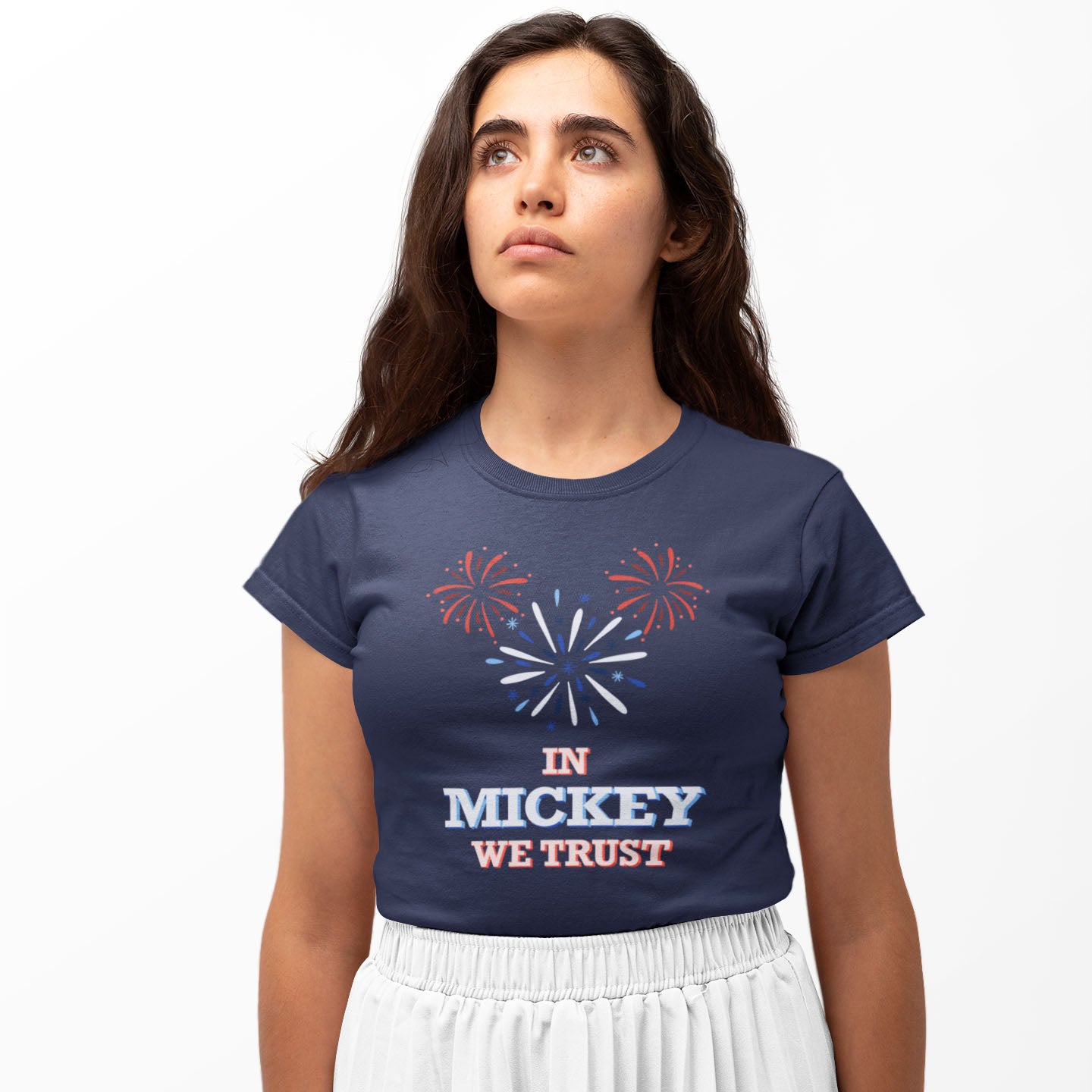 Modeled product image of Moxie•Pop's unisex graphic tee with hand-drawn fireworks in the shape of Mickey Mouse silhouette with the phrase "In Mickey We Trust"  in navy