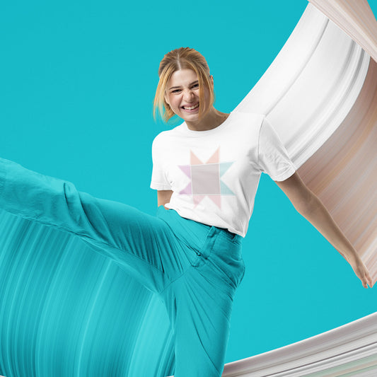 Modeled image of Moxie•Pop's unisex graphic tee with a pastel sawtooth star quilt block design in white. Model is wearing turquoise pants. 