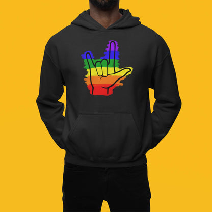 Moxie•Pop's unisex graphic hoodie with colored rainbow stripes behind a black ASL I love you hand sign icon design in black modeled by a man with a yellow backdrop