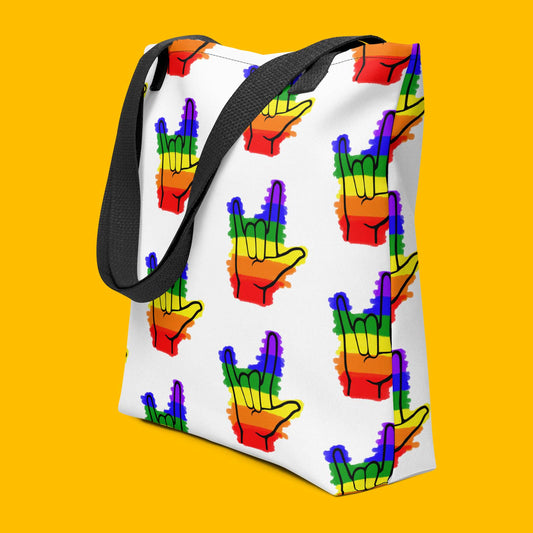 Ghost product image of Moxie•Pop's all over print tote with a seamless design of colored in asl I love you hand sign with rainbow stripes with black straps and yellow backdrop