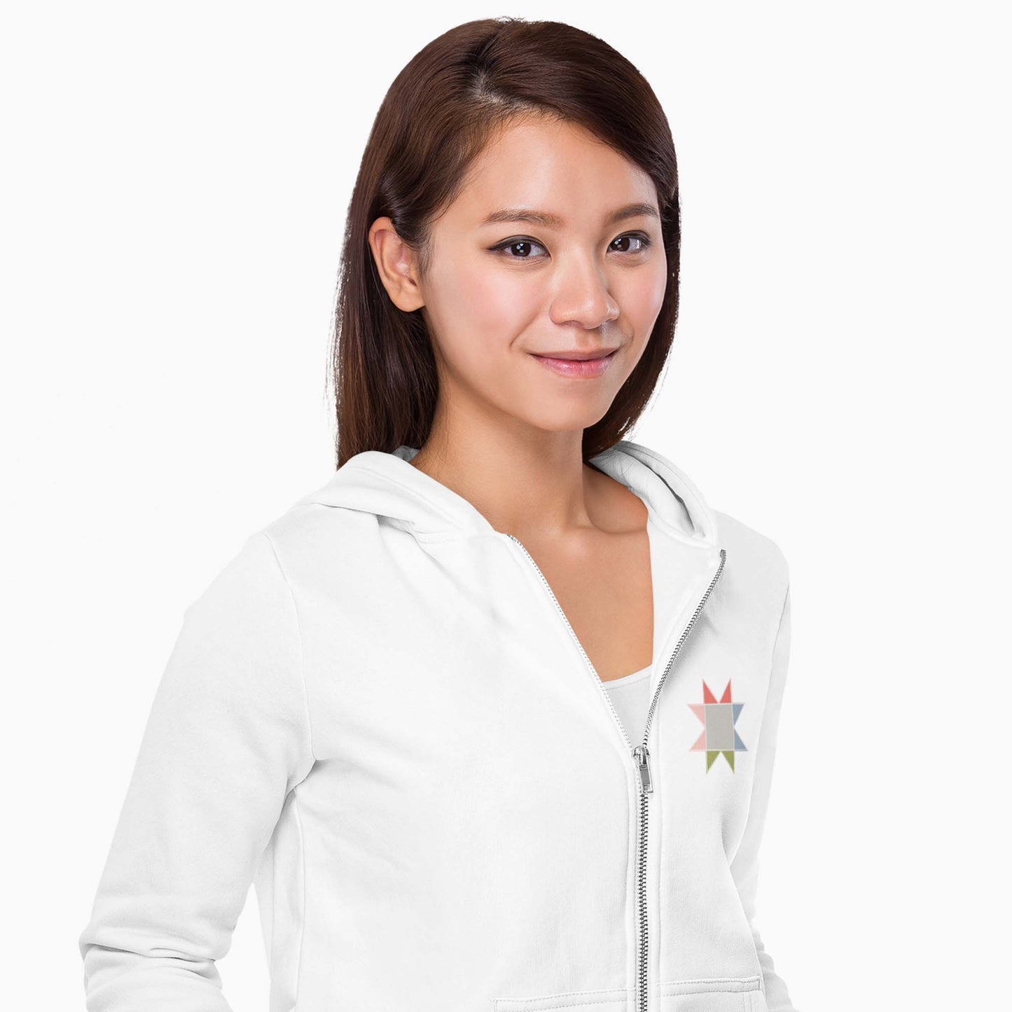 Front of Moxie•Pop's unisex zip hoodie in white with small sawtooth star quilt block on left chest modeled by a woman with long hair and a white backdrop