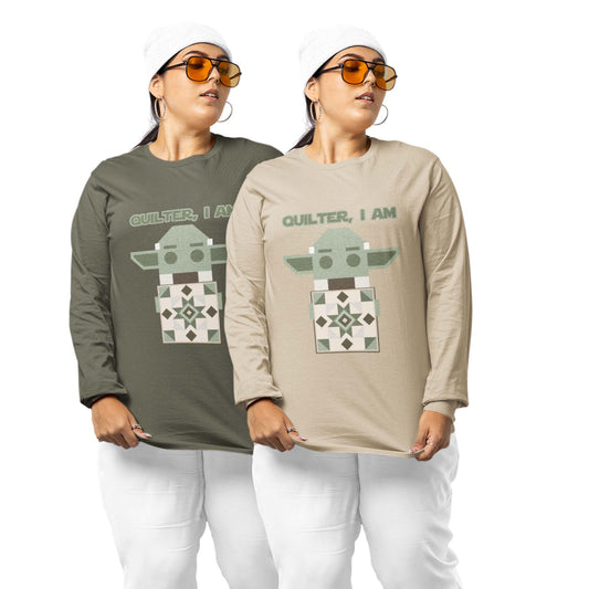 Moxie•Pop's men's long sleeve graphic tee with a geometric Yoda holding a quilt with the phrase "Quilter, I am" design in military green and sand modeled by a two women wearing a white beanies, sunglasses, and white sweatpants. 