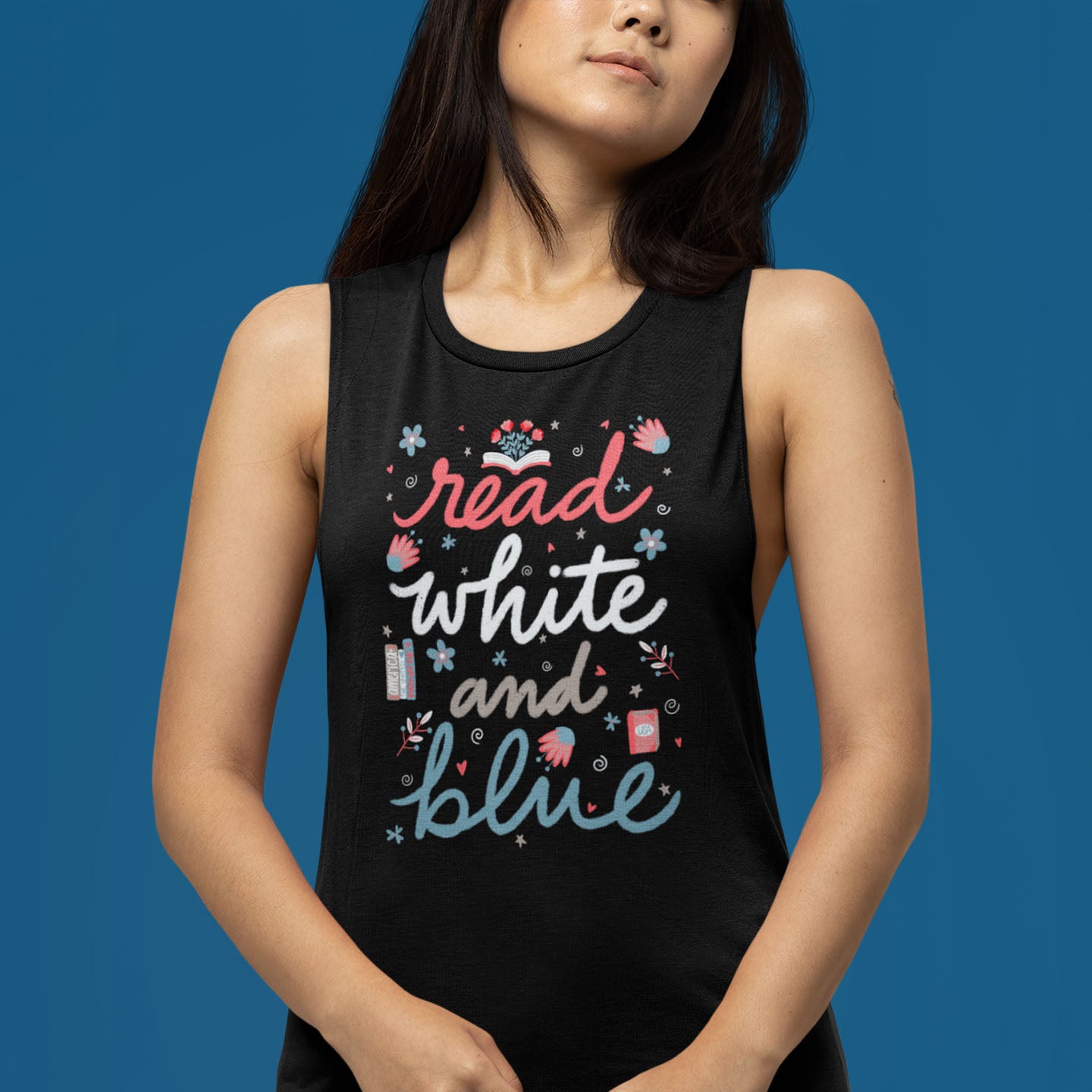 Modeled product image of Moxie•Pop's women's muscle tank with a "Read White and Blue" surrounded by flowers and books design in black heather