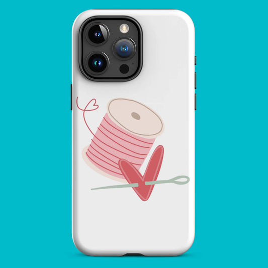 Product image of Moxie•Pop's tough case for iPhones® with a hand-drawn spool of pink thread and a heart pierced by a needle with a turquoise backdrop