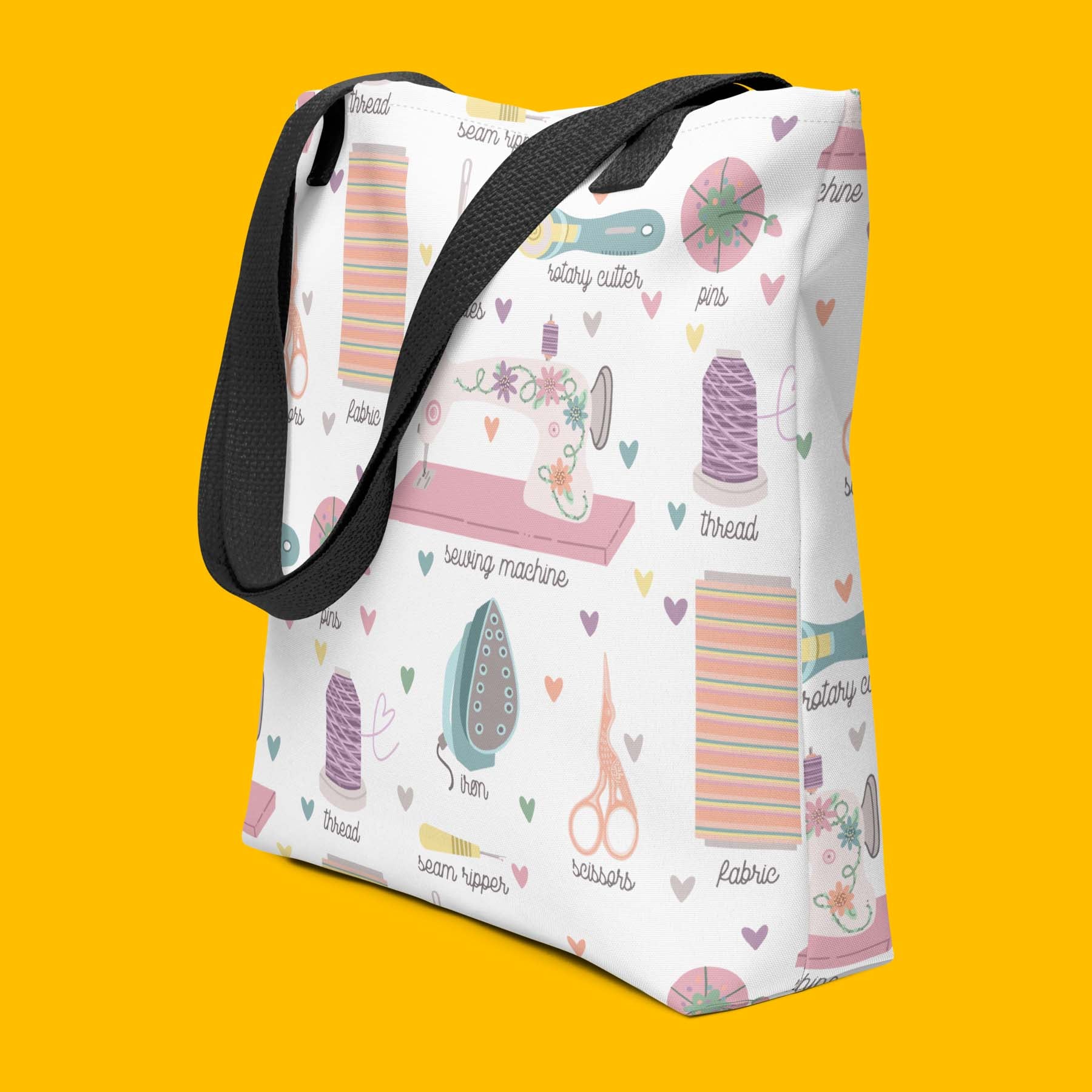 Moxie•Pop's  tote bag with a series of hand-drawn sewing tools with their names below design product image with yellow backdrop