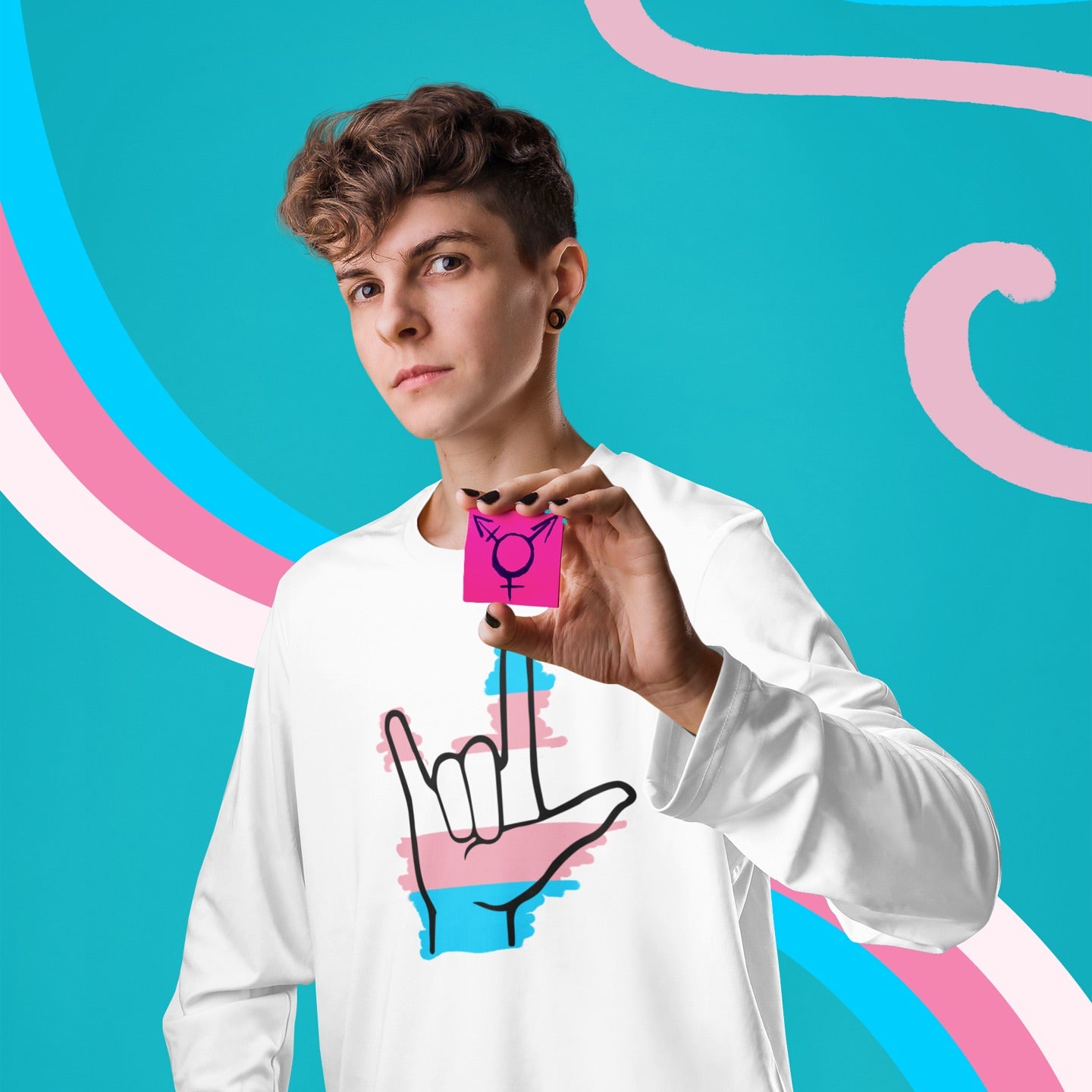 Modeled product image of Moxie•Pop's men's long sleeve graphic tee with blue, pink, and white stripes behind a black ASL I love you hand sign icon in support of transgendered design in white 