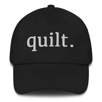 Ghost product image of Moxie•Pop's embroidered dad hat with the word "quilt." in black