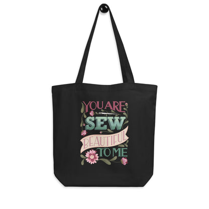 Hanging product image of Moxie•Pop's eco tote bag with "You are Sew Beautiful to me" in lavender with flowers in black