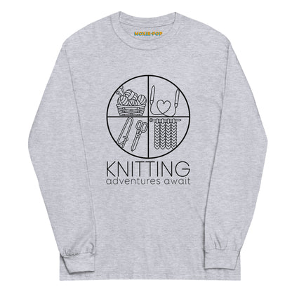 Lay flat product image of Moxie•Pop's men's long sleeve graphic tee with "KNITTING adventures await" below a circle filled with knitting implements icons design in sport grey