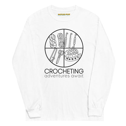 Lay flat product image of Moxie•Pop's mens' long sleeve graphic tee with "CROCHETING adventures await" below a circle filled with crocheting implements icons design in white