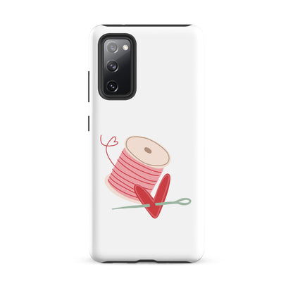 Product image of Moxie•Pop's tough case for Samsung® with a hand-drawn spool of pink thread and a heart pierced by a needle on a Galaxy S20 fe