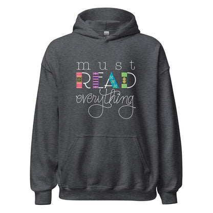 Ghost product image of Moxie•Pop's unisex graphic hoodie with 'Must Read Everything' with the downstroke of the word READ is created with hand drawn book spines in dark grey heather