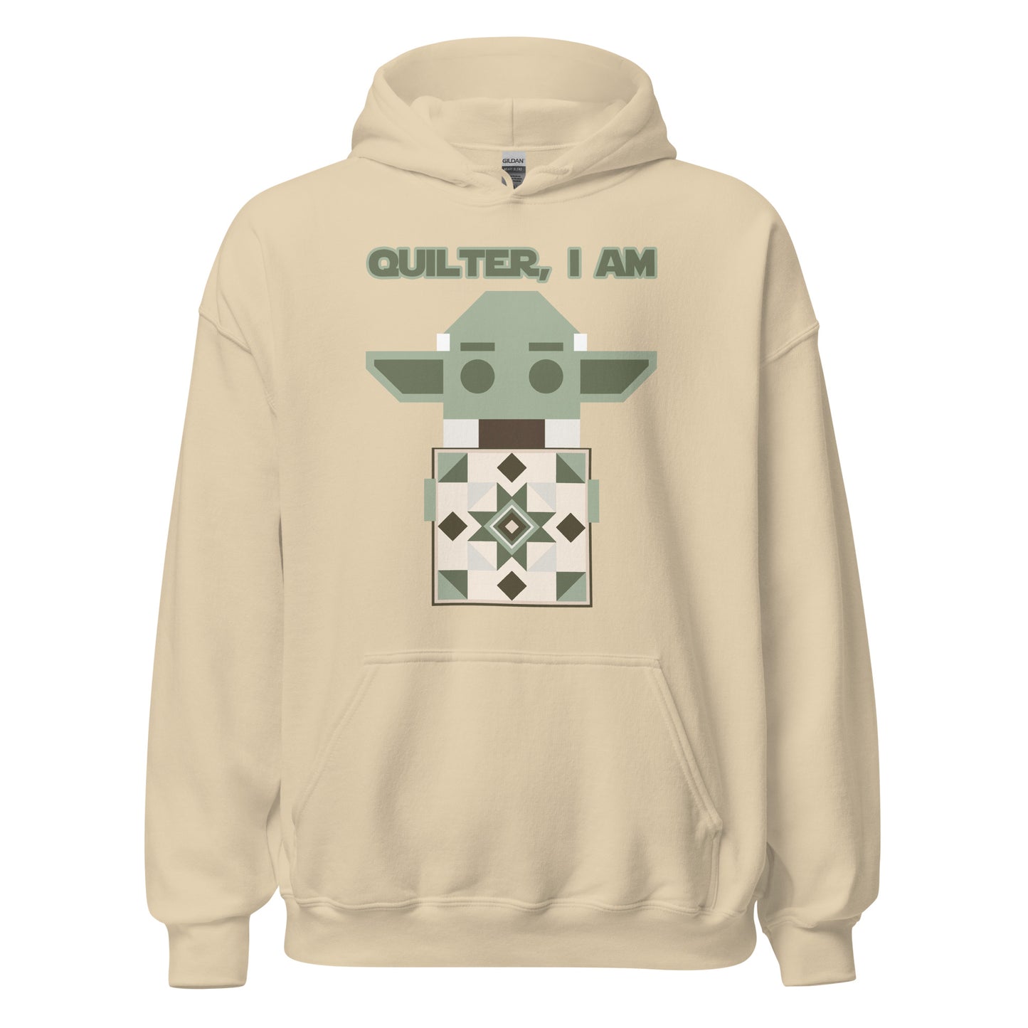 Lay flat product image of Moxie•Pop's unisex graphic hoodie with a geometric Yoda holding a quilt with the phrase "Quilter, I am" design in sand