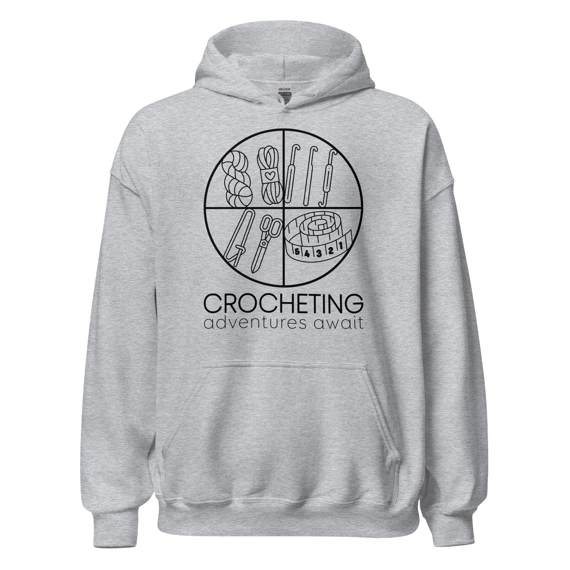 Ghost product image of Moxie•Pop's unisex graphic hoodie with "CROCHETING adventures await" below a circle filled with crocheting implements icons design in sport grey