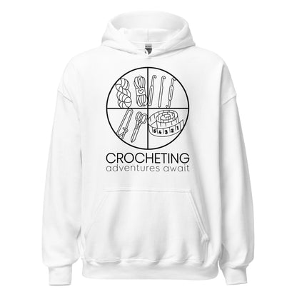 Ghost product image of Moxie•Pop's unisex graphic hoodie with "CROCHETING adventures await" below a circle filled with crocheting implements icons design in white