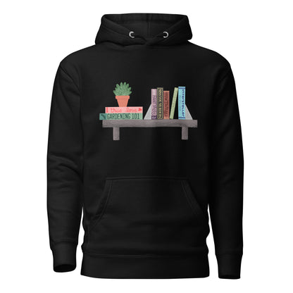 Ghost product image of Moxie•Pop's unisex graphic hoodie with a illustration of a shelf, a series of books atop, and a house plant in black