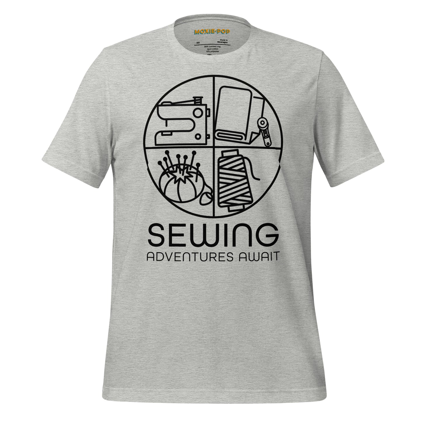 Ghost product image Moxie•Pop's unisex graphic tee with a black circle outline in four quadrants each with a sewing tool icon above 'Sewing Adventures Await' in athletic heather