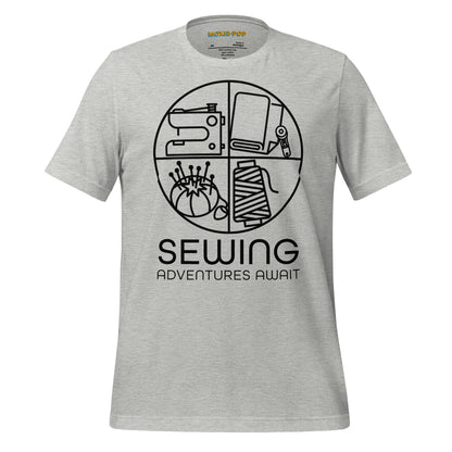 Ghost product image Moxie•Pop's unisex graphic tee with a black circle outline in four quadrants each with a sewing tool icon above 'Sewing Adventures Await' in athletic heather