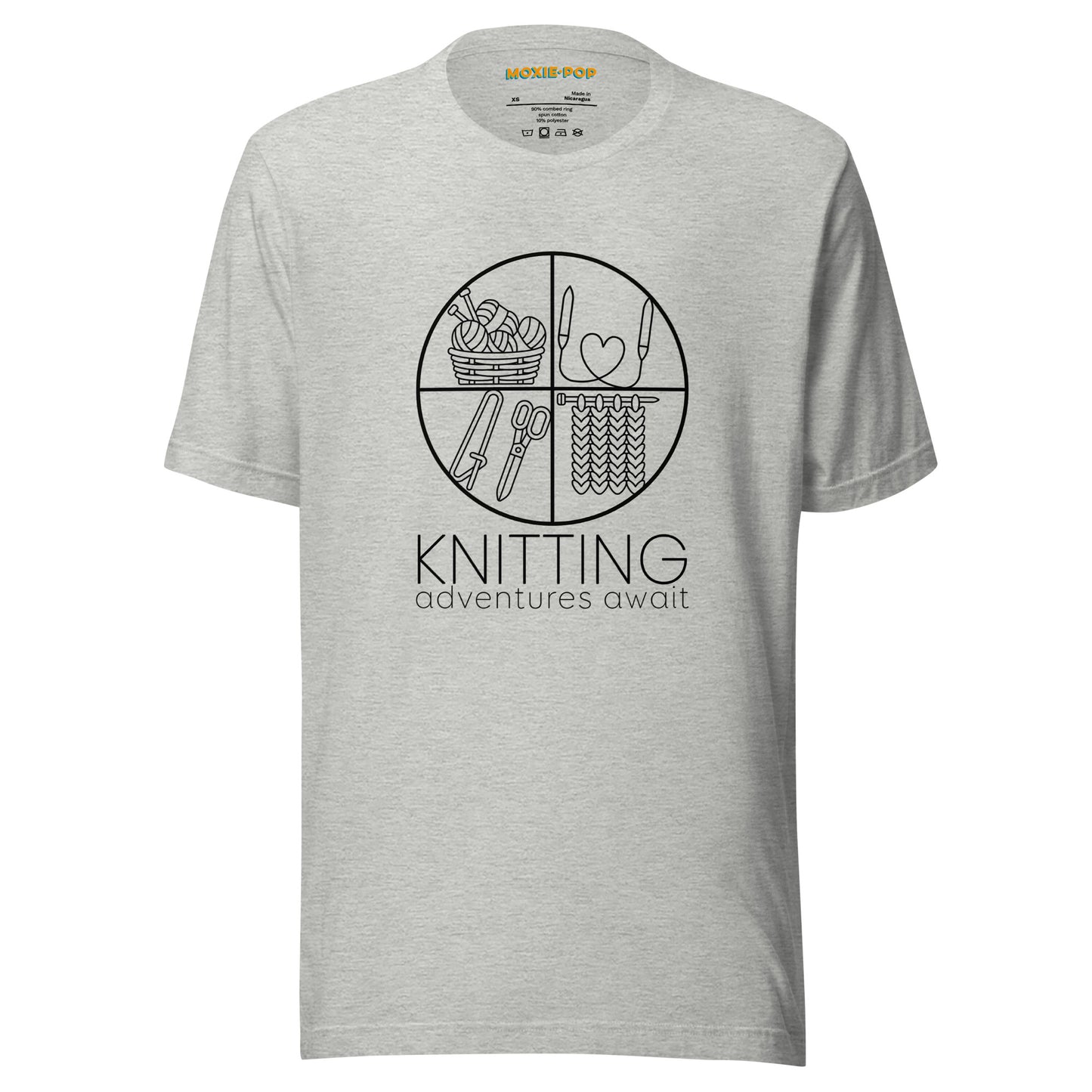 Ghost product image of Moxie•Pop's unisex graphic tee with "KNITTING adventures await" below a circle filled with knitting implements icons design in athletic heather