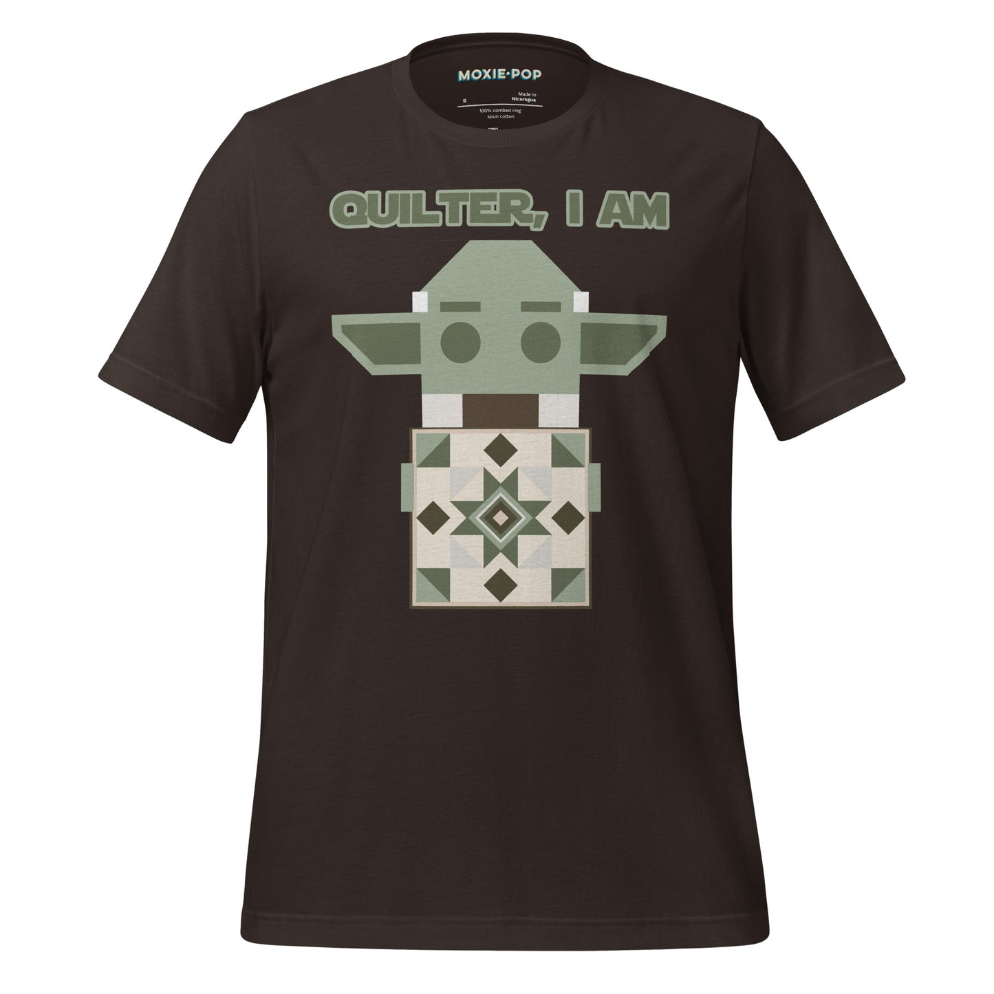 Lay flat product image of Moxie•Pop's unisex graphic tee with a geometric Yoda holding a quilt with the phrase "Quilter, I am" design in brown