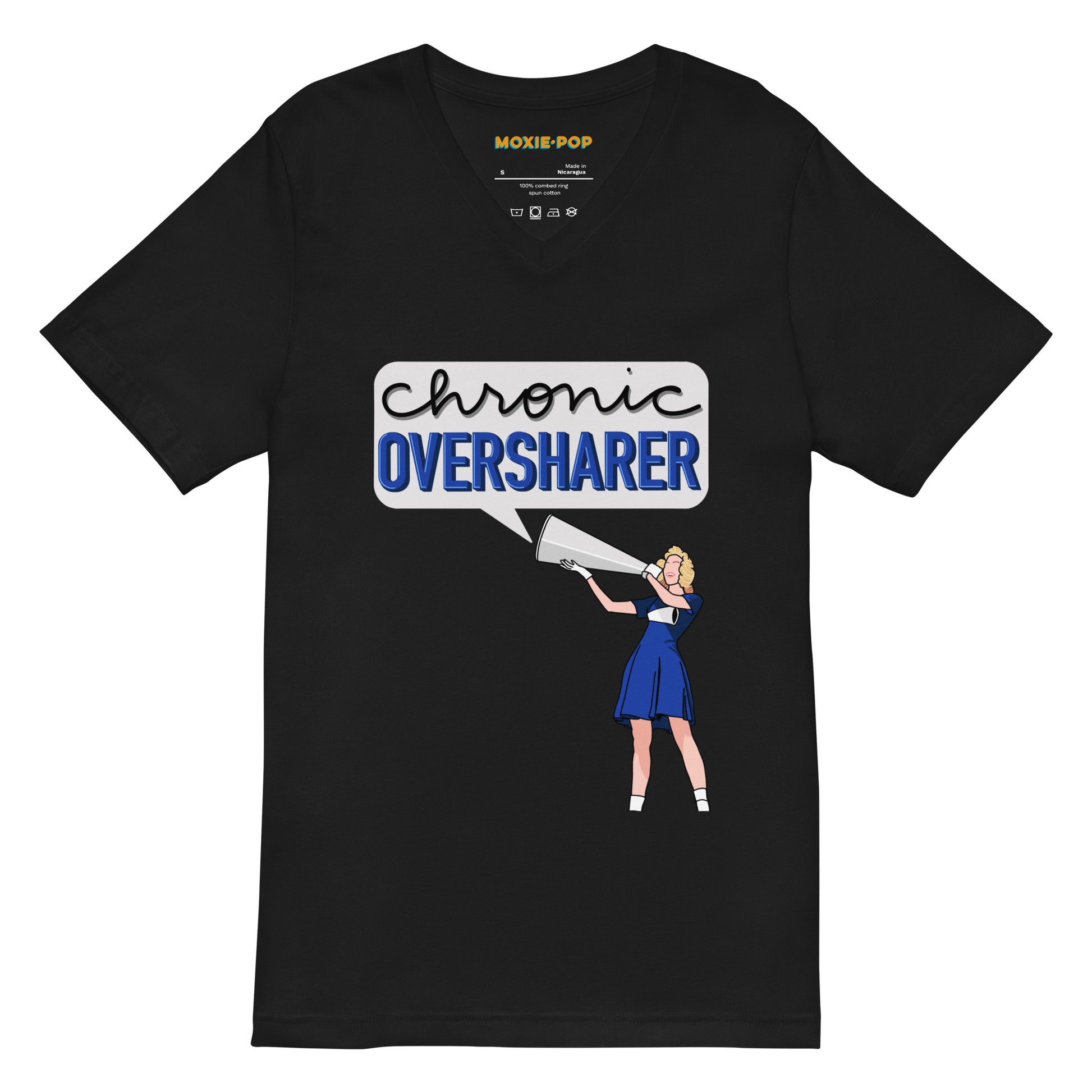 Lay flat product image of Moxie•Pop's unisex v-neck graphic tee with a illustration of a vintage cheerleader yelling into a megaphone with a talk bubble announcing 'Chronic Oversharer' in black