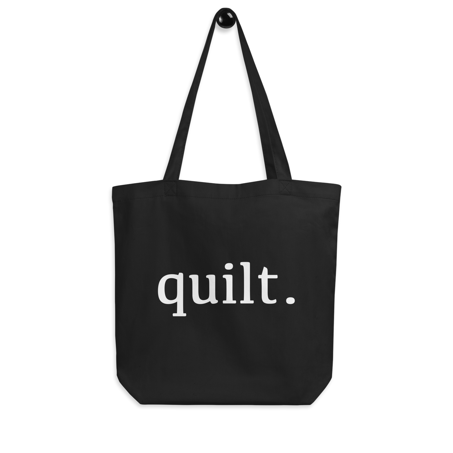 Moxie•Pop's eco graphic tote bag with 'quilt.' design product image hanging in black