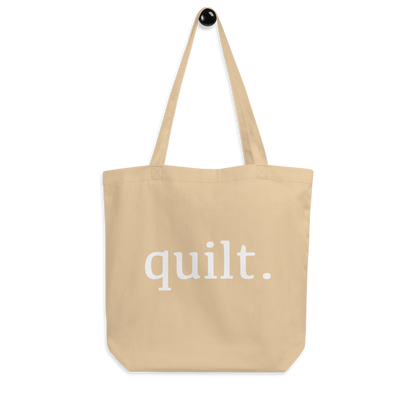 Moxie•Pop's eco graphic tote bag with 'quilt.' design product image hanging in oyster.