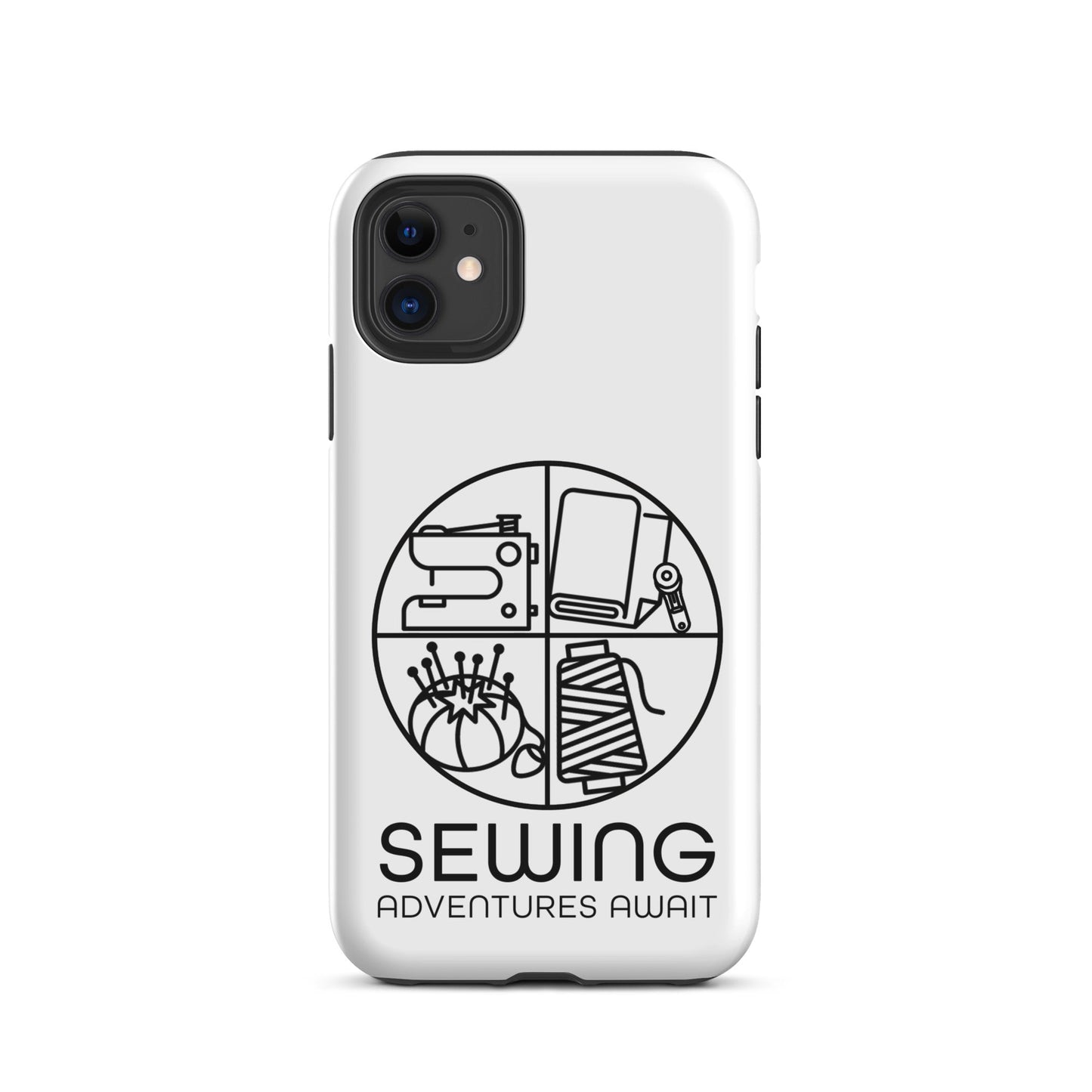 Moxie•Pop's tough case on a iPhone® in white with a black image of a circle in four quadrants each with a sewing tool icon above 'Sewing Adventures Await'. 