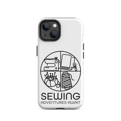 Moxie•Pop's tough case on a iPhone® in white with a black image of a circle in four quadrants each with a sewing tool icon above 'Sewing Adventures Await'. 