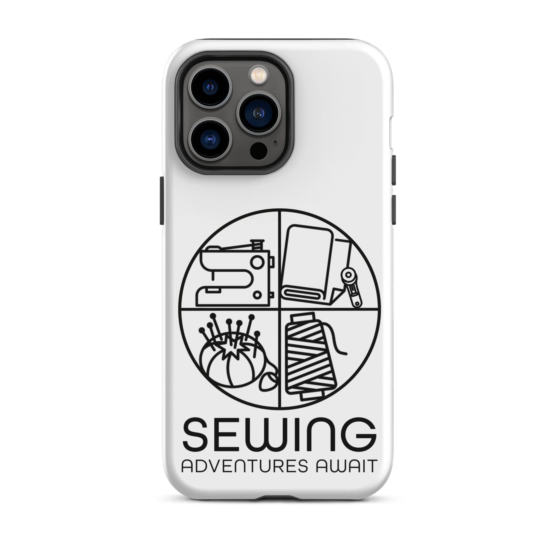 Moxie•Pop's tough case on a iPhone® in white with a black image of a circle in four quadrants each with a sewing tool icon above 'Sewing Adventures Await'. 