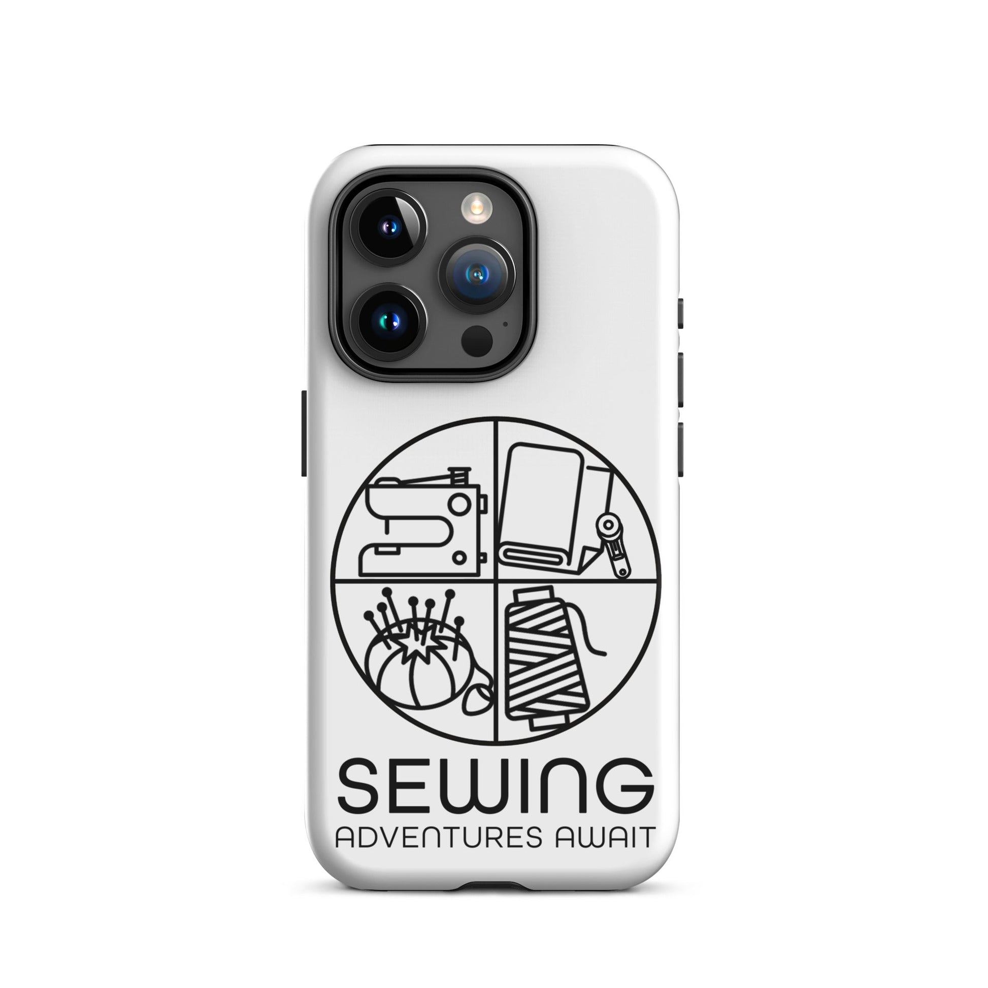 Moxie•Pop's tough case on a iPhone® in white with a black image of a circle in four quadrants each with a sewing tool icon above 'Sewing Adventures Await'. 