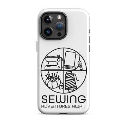 Moxie•Pop's tough case on a iPhone® in white with a black image of a circle in four quadrants each with a sewing tool icon above 'Sewing Adventures Await'. 