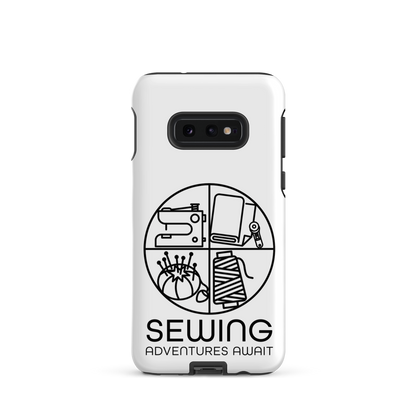 Moxie•Pop's tough case on a Samsung® in white with a black image of a circle in four quadrants each with a sewing tool icon above 'Sewing Adventures Await'. 