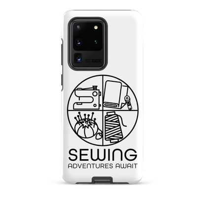 Moxie•Pop's tough case on a Samsung® in white with a black image of a circle in four quadrants each with a sewing tool icon above 'Sewing Adventures Await'. 