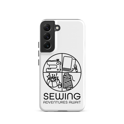 Moxie•Pop's tough case on a Samsung® in white with a black image of a circle in four quadrants each with a sewing tool icon above 'Sewing Adventures Await'. 