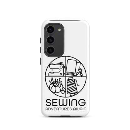 Moxie•Pop's tough case on a Samsung® in white with a black image of a circle in four quadrants each with a sewing tool icon above 'Sewing Adventures Await'. 